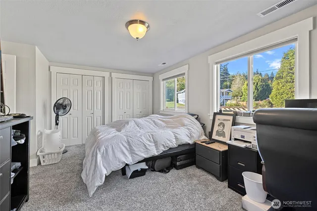 a spacious bedroom with a bed and a window