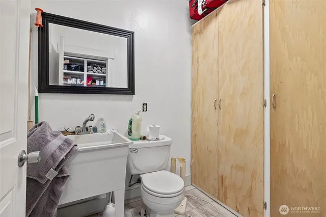 a bathroom with a toilet sink and mirror