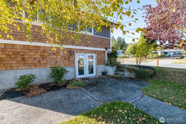 a view of a house with a yard and tree s