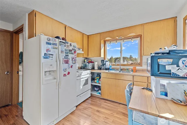 a kitchen with stainless steel appliances a refrigerator and a stove top oven