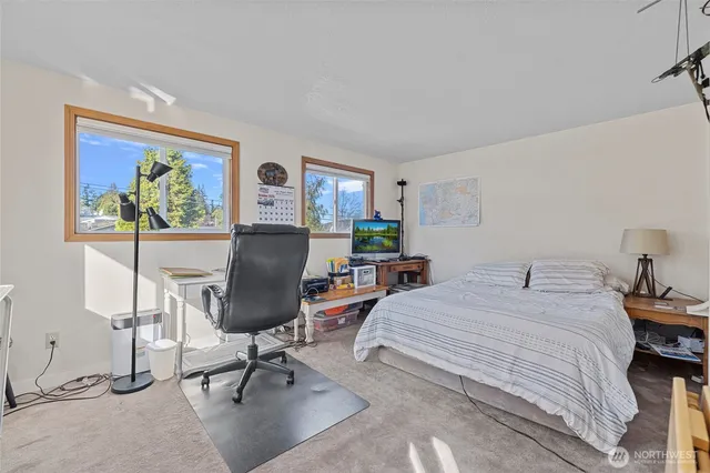 a bedroom with a large bed and a chandelier