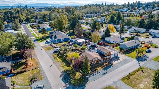 an aerial view of a houses with a swimming pool
