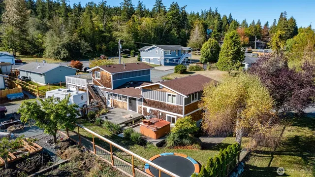 an aerial view of multiple houses with yard