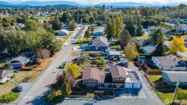 an aerial view of a houses with a swimming pool