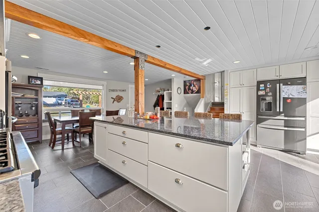 a kitchen with stainless steel appliances granite countertop a sink and cabinets