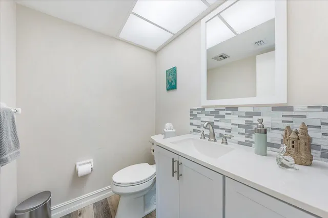a bathroom with a sink a toilet and mirror