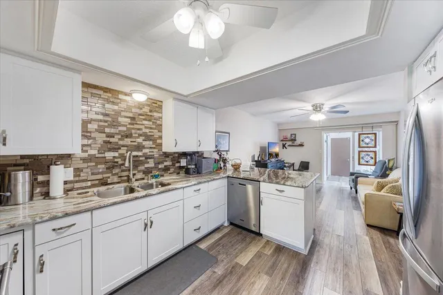 a kitchen with sink stove and cabinets