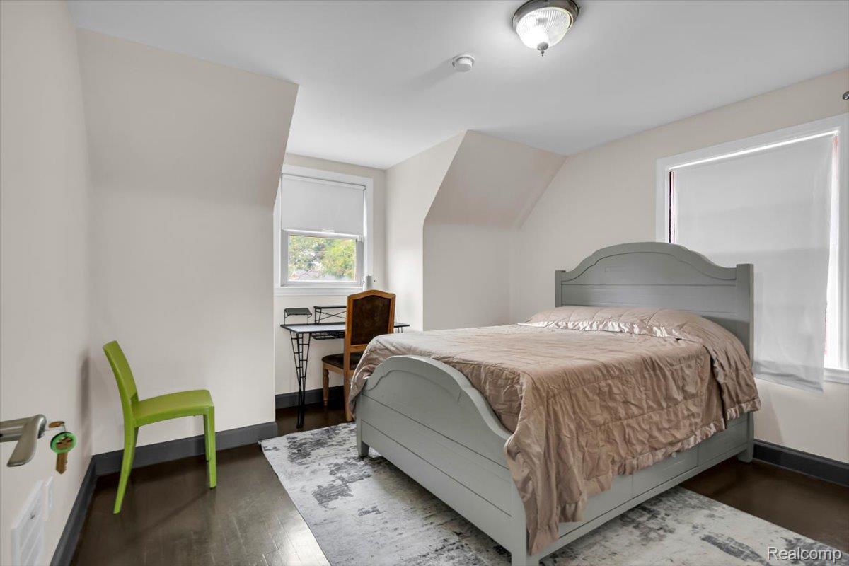 476 Touraine Road Grosse Pointe, MI 48236 - Photo 19 of 30 Hardwood flooring, sloped ceiling details, and a flush mount lighting fixture