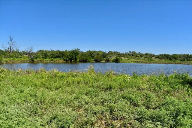 a view of a lake with houses in the back