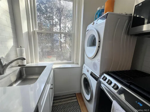 a utility room with sink dryer and washer