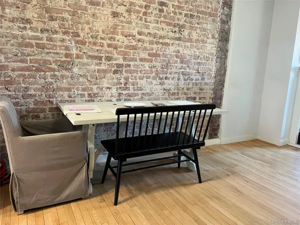 a balcony with a couch and a wooden floor