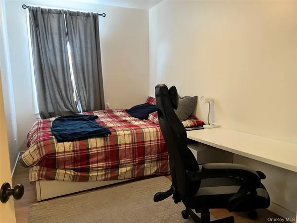 a bedroom with a bed and a desk