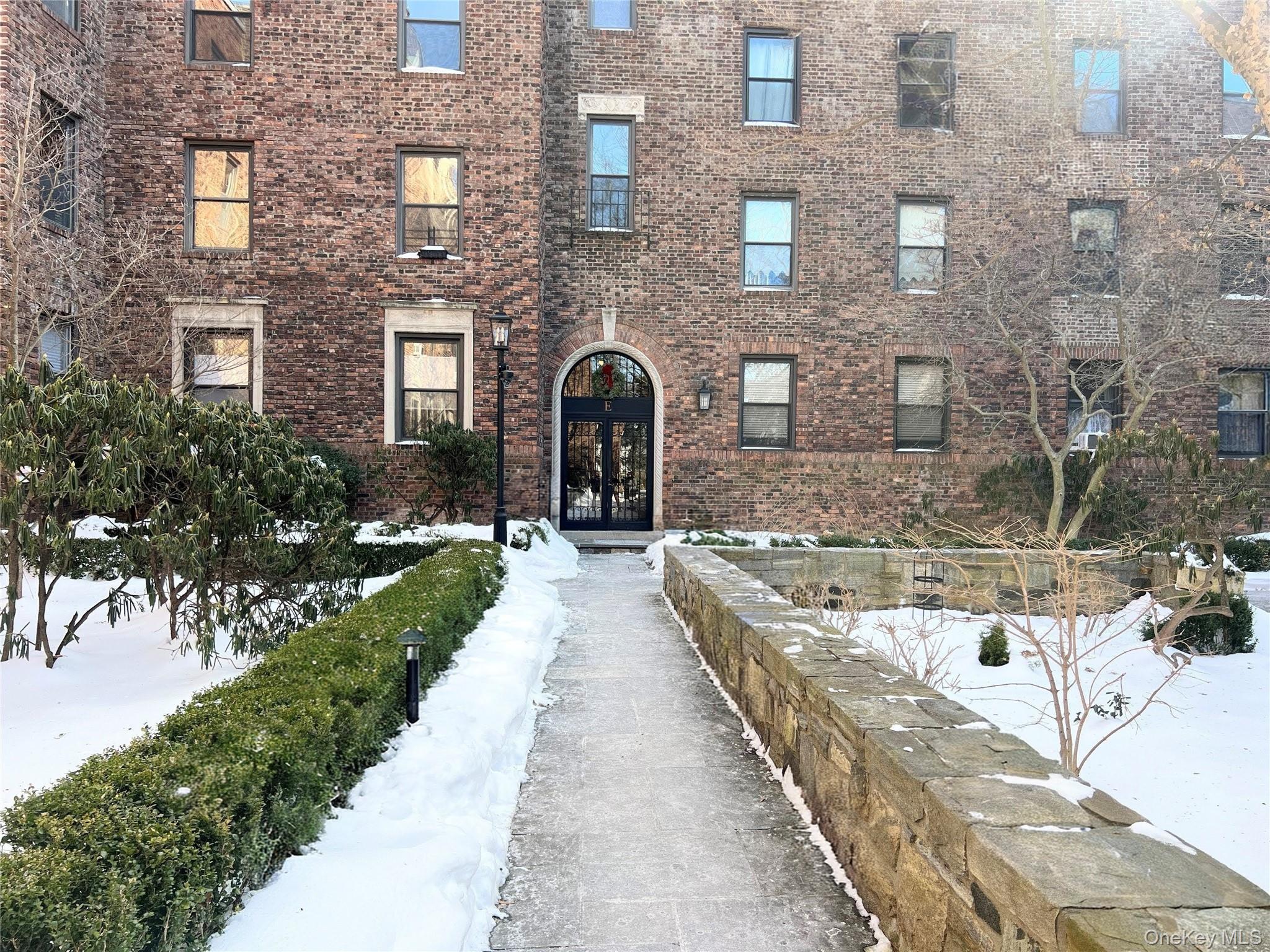 64 Sagamore Road, Unit E6 Bronxville, NY 10708 - Photo 17 of 18 a view of a brick house with a large windows