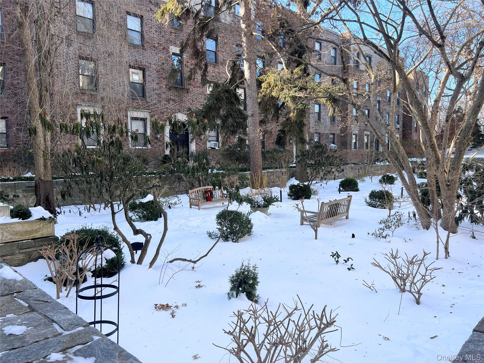 64 Sagamore Road, Unit E6 Bronxville, NY 10708 - Photo 18 of 18 a view of backyard of a building with seating space and trees