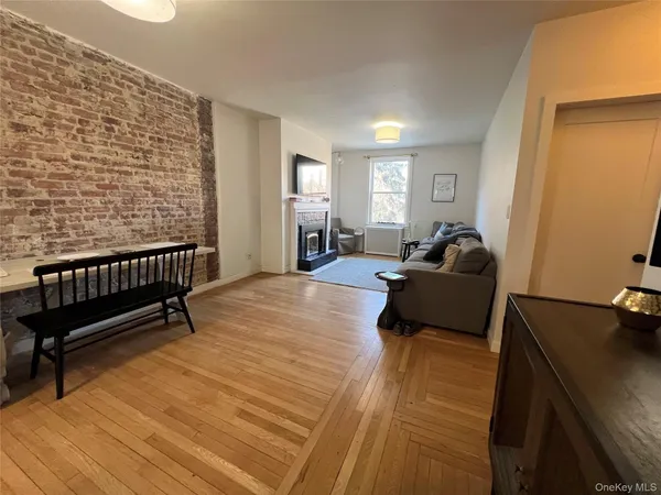 a spacious bedroom with a bed and wooden floor