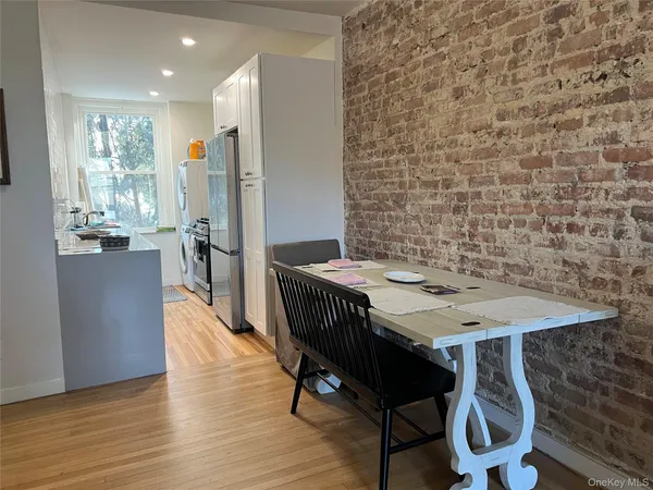 a view of a dining room with furniture window and wooden floor