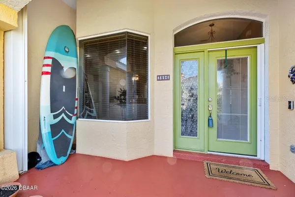 an aerial view of ocean and residential houses with outdoor space
