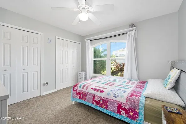 a bedroom with a bed a desk and chair