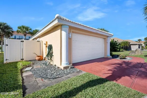a view of a small house with backyard