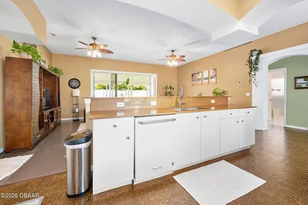 a kitchen with stainless steel appliances granite countertop a refrigerator a stove and white cabinets