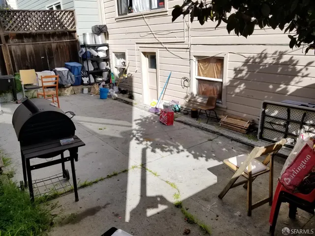 a view of a patio with table and chairs and potted plants