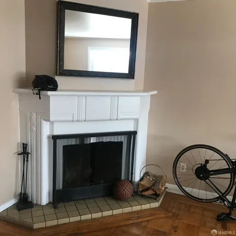 a living room with a fireplace a rug and a window