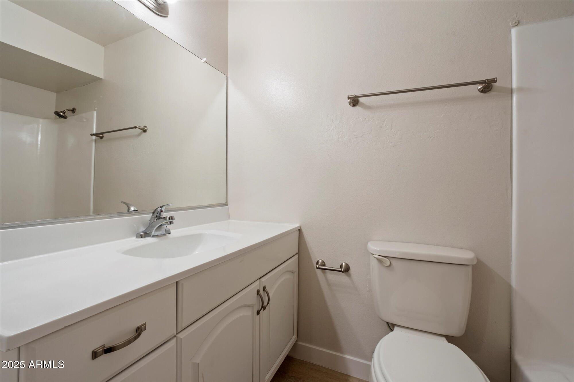 8055 East Thomas Road, Unit A202 Scottsdale, AZ 85251 - Photo 18 of 30 a bathroom with a toilet sink and mirror