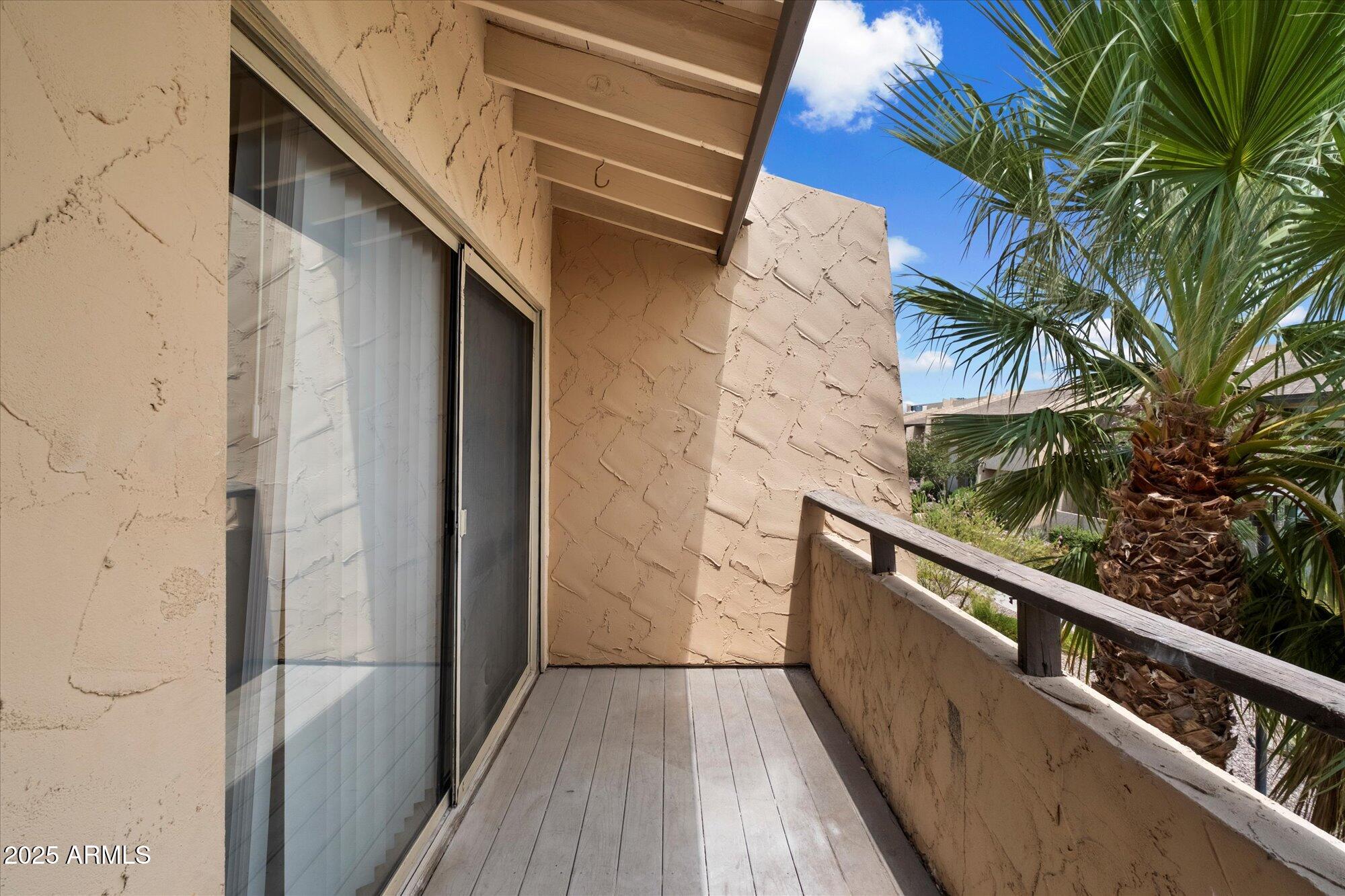 8055 East Thomas Road, Unit A202 Scottsdale, AZ 85251 - Photo 20 of 30 a view of balcony with wooden floor and fence