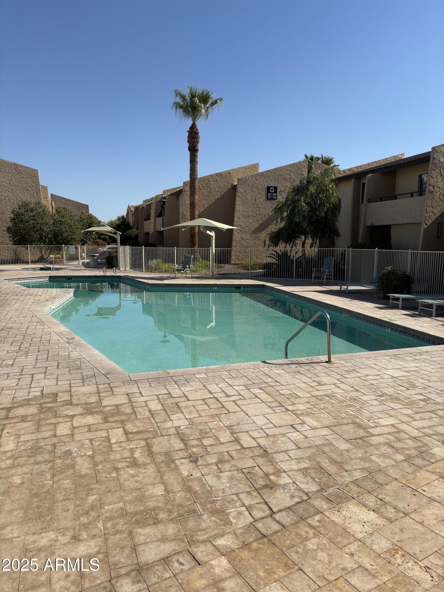 8055 East Thomas Road, Unit A202 Scottsdale, AZ 85251 - Photo 30 of 30 a view of a swimming pool with a yard