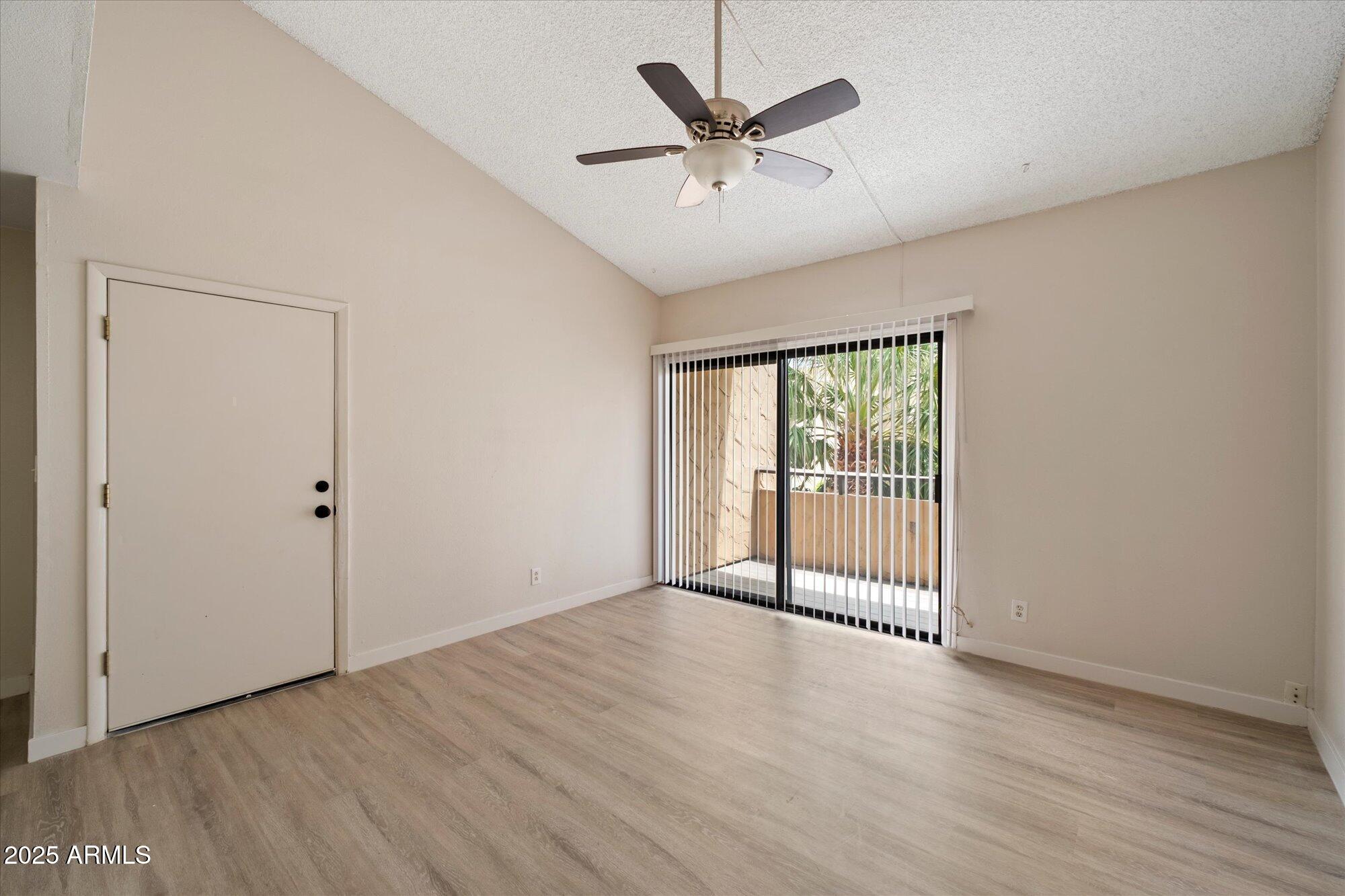 8055 East Thomas Road, Unit A202 Scottsdale, AZ 85251 - Photo 3 of 30 an empty room with wooden floor and windows
