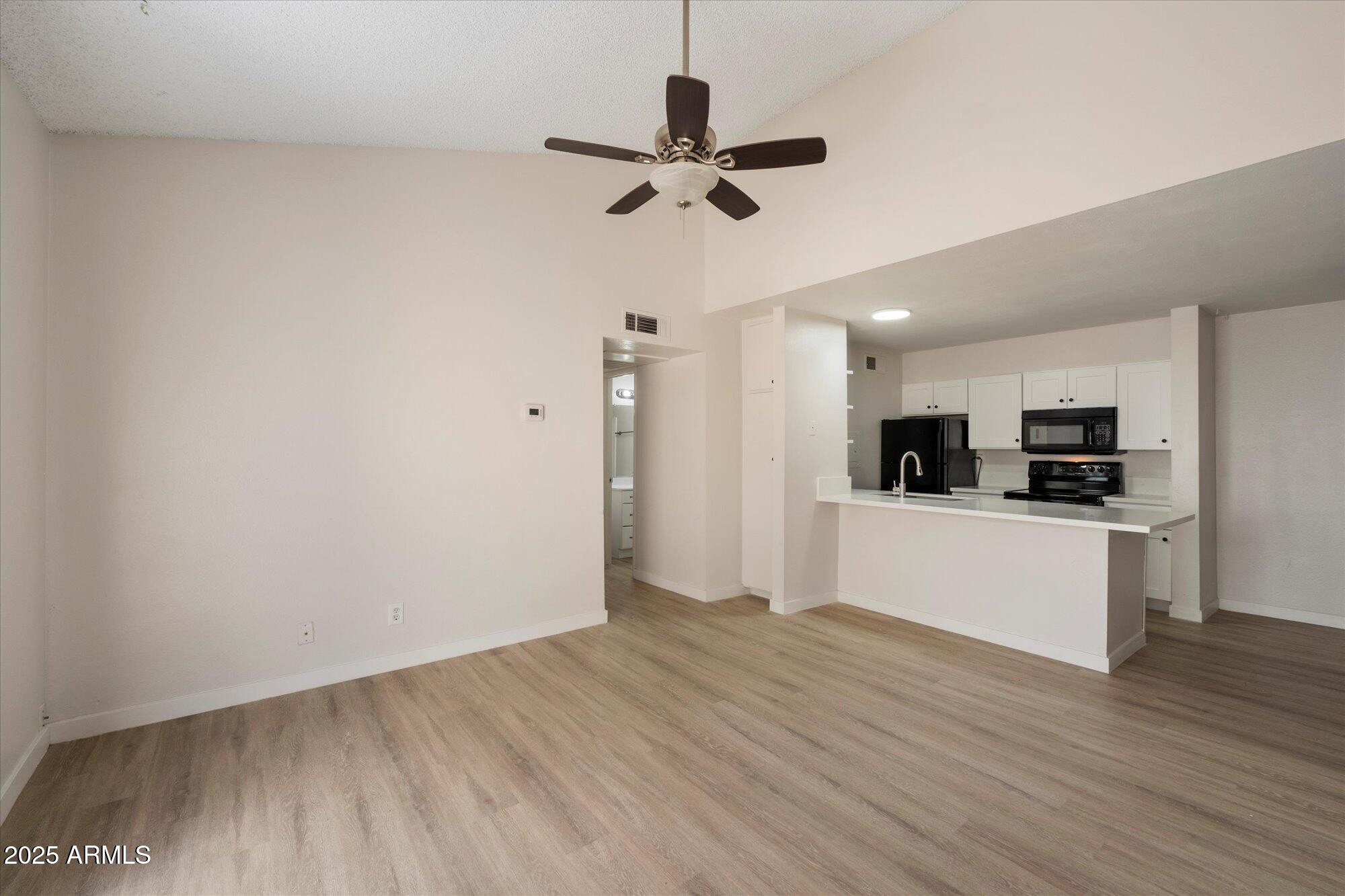 8055 East Thomas Road, Unit A202 Scottsdale, AZ 85251 - Photo 5 of 30 a view of kitchen with sink microwave refrigerator and stove