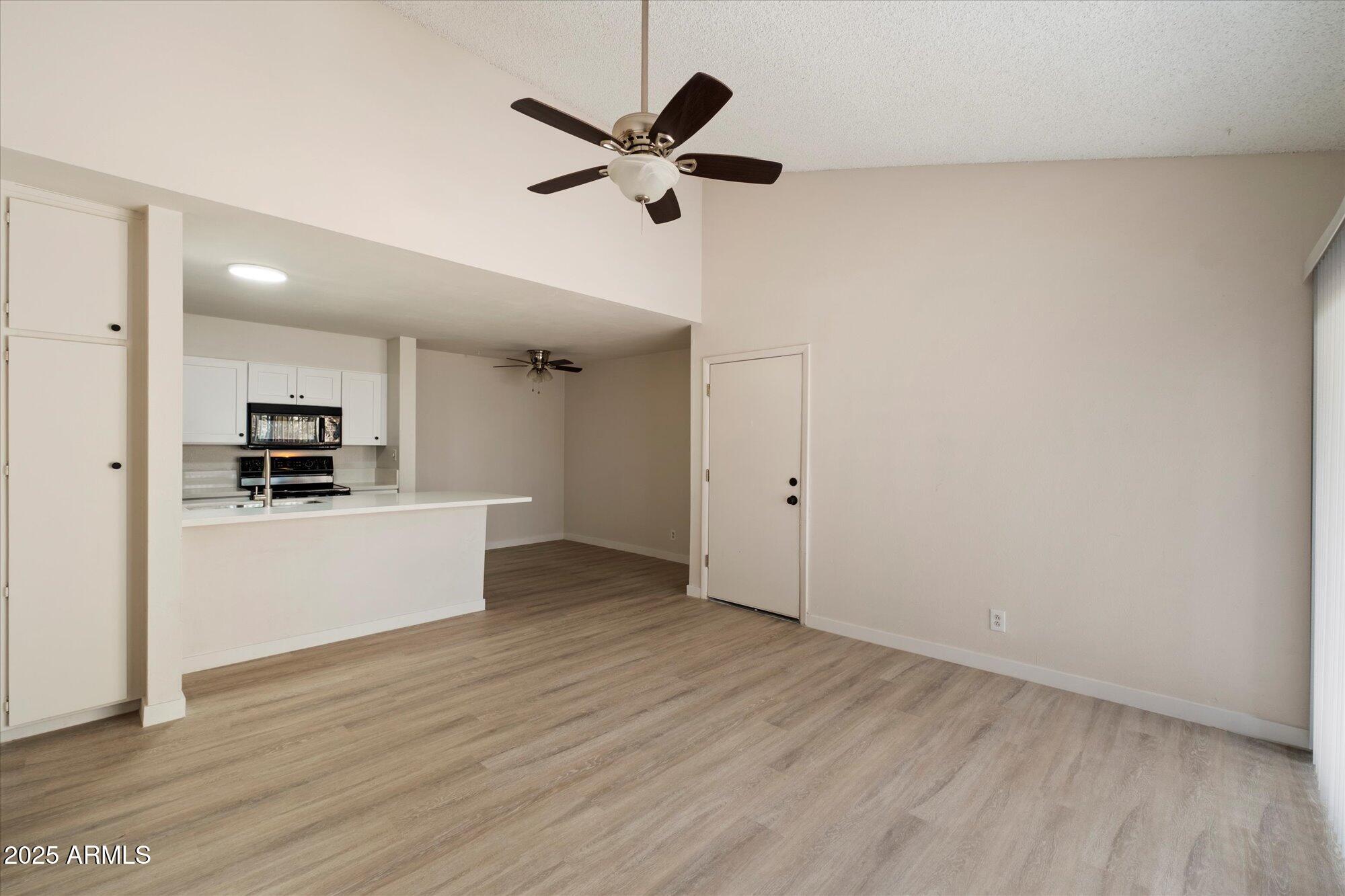 8055 East Thomas Road, Unit A202 Scottsdale, AZ 85251 - Photo 6 of 30 a view of a kitchen with a sink stainless steel appliances and cabinets