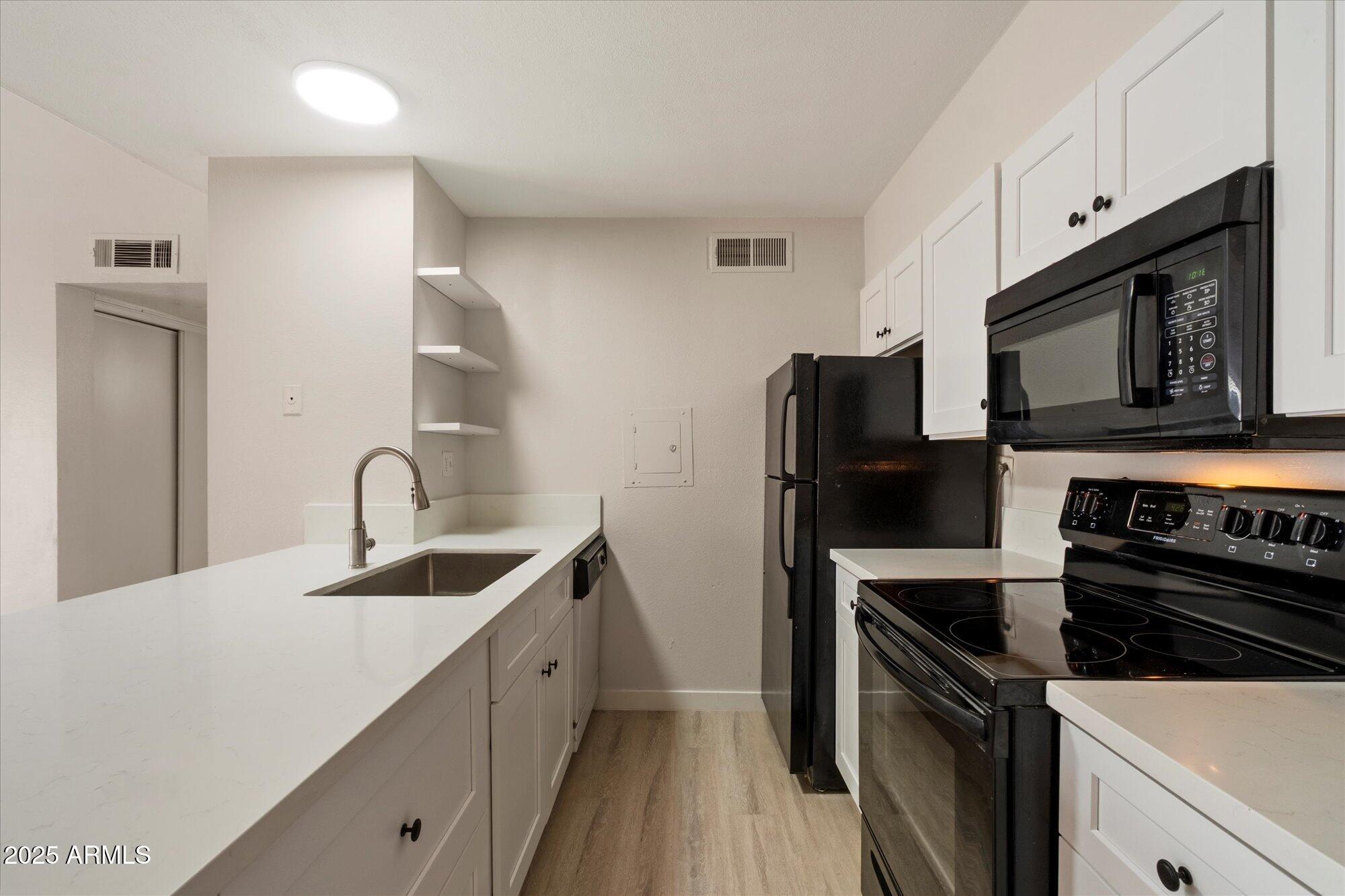 8055 East Thomas Road, Unit A202 Scottsdale, AZ 85251 - Photo 9 of 30 a kitchen with a sink stove and refrigerator