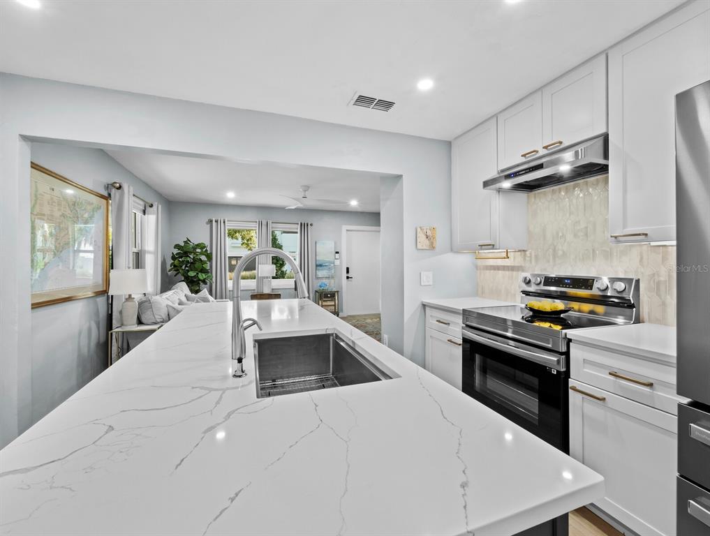 2421 Prospect Street Sarasota, FL 34239 - Photo 7 of 26 a kitchen with granite countertop a sink stainless steel appliances and cabinets