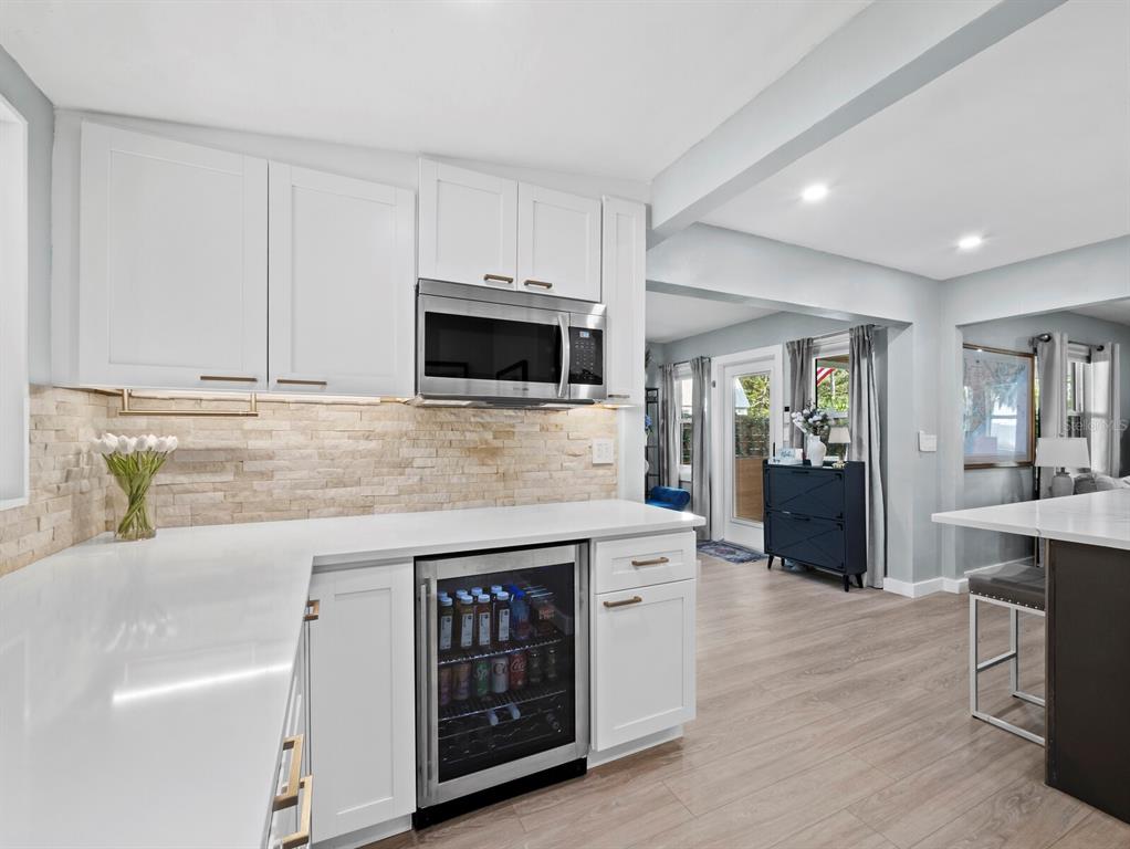 2421 Prospect Street Sarasota, FL 34239 - Photo 8 of 26 a kitchen with stainless steel appliances granite countertop a stove a sink and a microwave