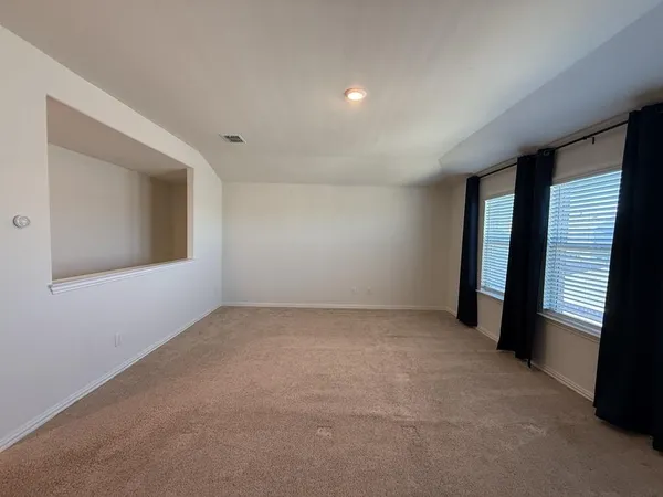 an empty room with a empty space and windows