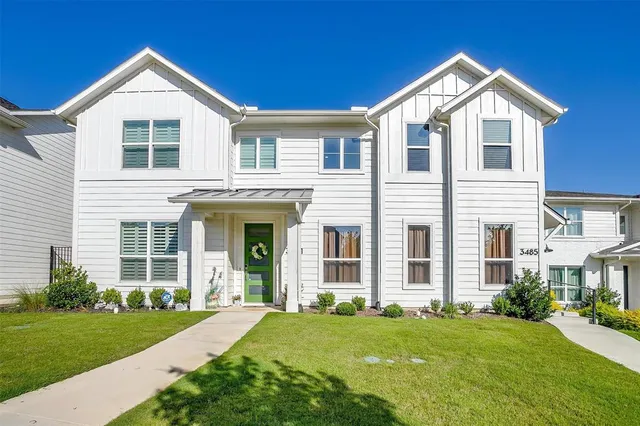 a front view of a house with a yard and porch
