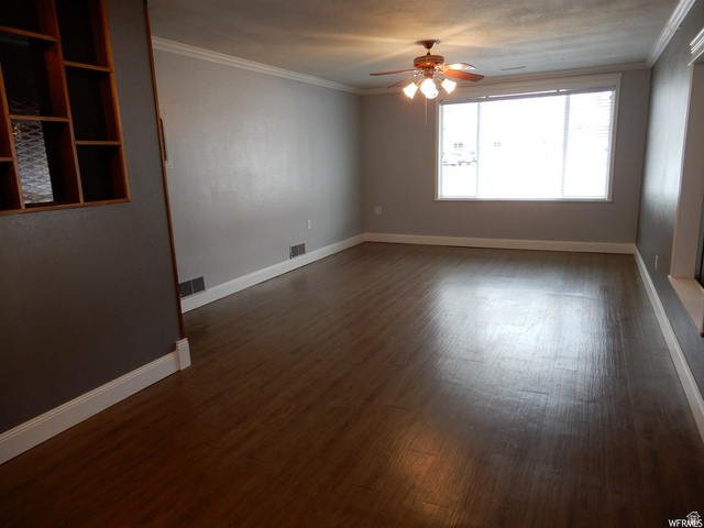 490 Averett Avenue Springville, UT 84663 - Photo 6 of 14 Spacious interior showcasing wood-finish flooring, light gray wall paint, and white crown molding