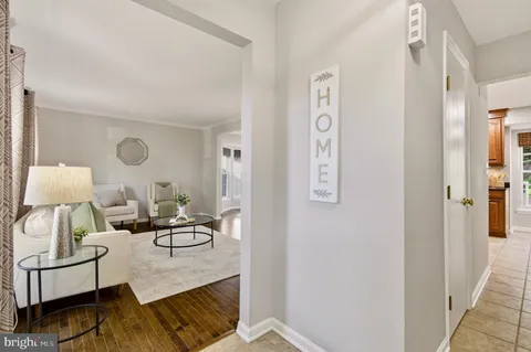 a living room with furniture and a lamp