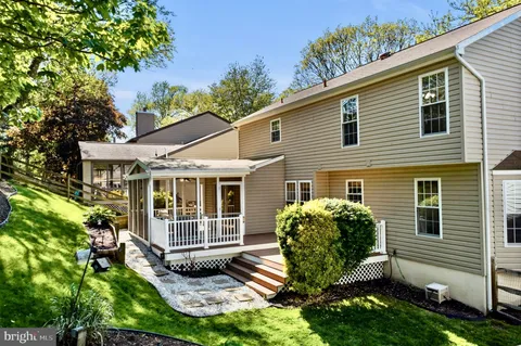 an aerial view of house with yard and outdoor seating