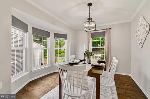 a view of a dining room with furniture wooden floor and a chandelier