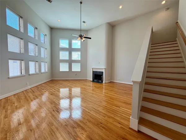 a view of empty room with wooden floor and fireplace
