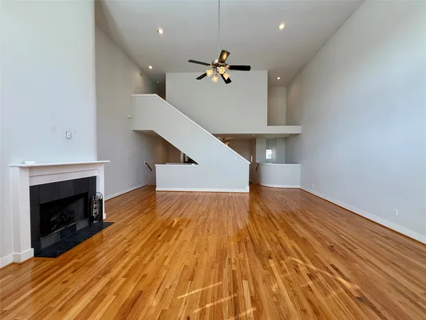 a view of a big room with windows a fireplace and a chandelier