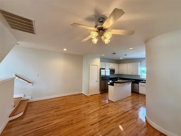 a view of kitchen with sink and wooden floor