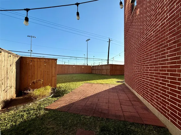 a view of a backyard with wooden fence
