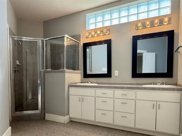 a bathroom with a double vanity sink and a mirror