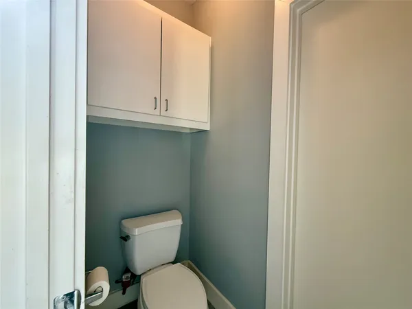 a white toilet sitting next to a sink