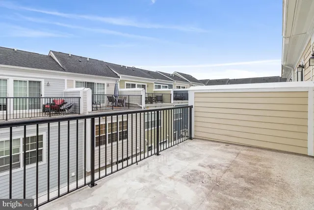 a view of a house with wooden fence
