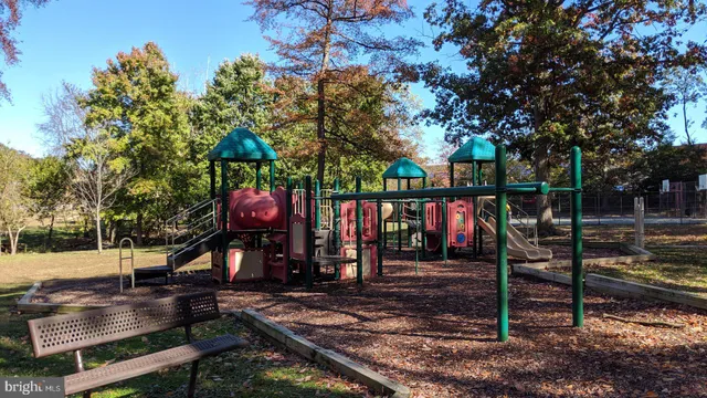 a view of a park with swings on the side of the road