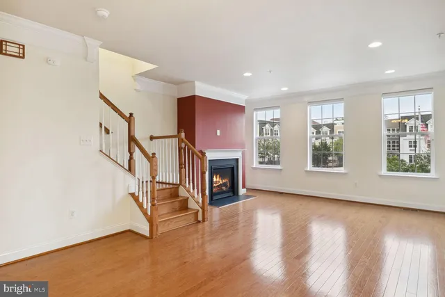 a view of an empty room with fireplace and a window